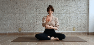 Woman practicicng nasagra mudra and pranayama